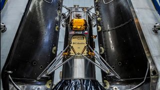 Intuitive Machines moon lander Im-1 sits between its SpaceX Falcon 9 rocket fairing ahead of launch