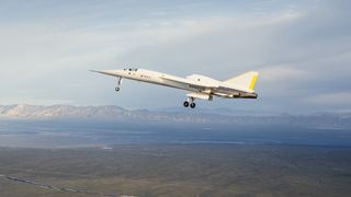 A needle-nosed white jet aircraft in flight