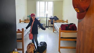 A girl poses inside a dorm room at SUNY Potsdam in New York.